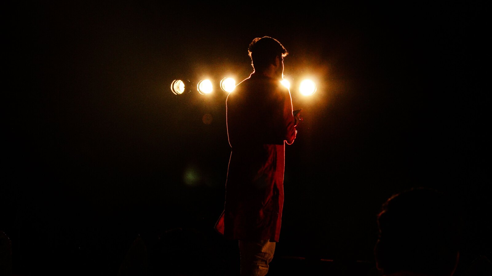 A band lit by warm amber stage light